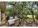 Balcony with an outdoor dining set overlooking trees and lawn at 153 High Hammock Villas, Seabrook Island, SC 29455