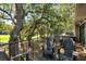 Comfortable outdoor seating on a deck overlooking a lush lawn surrounded by mature trees at 153 High Hammock Villas, Seabrook Island, SC 29455