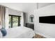 Bright bedroom featuring vaulted ceilings, stylish decor, and access to a private balcony at 153 High Hammock Villas, Seabrook Island, SC 29455