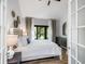 Bright bedroom featuring a comfortable bed, stylish decor, and access to a private balcony at 153 High Hammock Villas, Seabrook Island, SC 29455