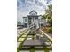 Landscaped backyard features a patio, lounge chairs, and a lush green lawn for outdoor enjoyment at 1537 Tomato Farm Cir, Mount Pleasant, SC 29464