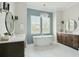 Luxurious bathroom with soaking tub, dual vanities, stylish fixtures, and modern lighting at 1537 Tomato Farm Cir, Mount Pleasant, SC 29464
