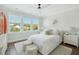 Bright bedroom featuring three windows, hardwood floors, and stylish décor and a surfboard accent at 1537 Tomato Farm Cir, Mount Pleasant, SC 29464