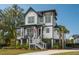Charming two-story home with landscaped yard, porch, and stairs leading to the front door at 1537 Tomato Farm Cir, Mount Pleasant, SC 29464