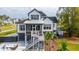 Charming two-story home with landscaped yard, patio seating, and elegant outdoor living at 1537 Tomato Farm Cir, Mount Pleasant, SC 29464
