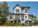 Charming two-story home featuring a welcoming front porch and well-manicured landscaping at 1537 Tomato Farm Cir, Mount Pleasant, SC 29464