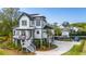 Charming two-story home featuring a welcoming front porch, well-manicured landscaping, and a spacious driveway, blending comfort and style at 1537 Tomato Farm Cir, Mount Pleasant, SC 29464