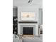 Fireplace with a beach art TV mounted on top of the stylish wood mantle and fireplace at 1537 Tomato Farm Cir, Mount Pleasant, SC 29464