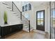 Bright foyer with staircase, artwork, and elevator access, creates a welcoming entrance at 1537 Tomato Farm Cir, Mount Pleasant, SC 29464