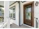 Elegant front door with glass panels, white siding, and stylish outdoor lighting fixtures at 1537 Tomato Farm Cir, Mount Pleasant, SC 29464