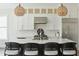 Modern kitchen with a stainless steel fridge and an island with bar stool seating and pendant lights at 1537 Tomato Farm Cir, Mount Pleasant, SC 29464