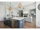 Open-concept kitchen featuring a large island, stainless steel appliances, and hardwood floors at 1537 Tomato Farm Cir, Mount Pleasant, SC 29464