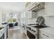Modern kitchen featuring stainless steel appliances, white cabinets, and eat-in dining area at 1537 Tomato Farm Cir, Mount Pleasant, SC 29464