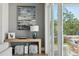 A sunny living room corner with a modern lamp, wood table, and view to the outdoor area at 1537 Tomato Farm Cir, Mount Pleasant, SC 29464