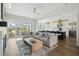 A living room with a connected, bright kitchen and access to the outside patio through sliding doors at 1537 Tomato Farm Cir, Mount Pleasant, SC 29464