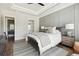 Bright main bedroom featuring a decorative accent wall, plush bedding, and hardwood floors at 1537 Tomato Farm Cir, Mount Pleasant, SC 29464