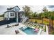 Backyard oasis with a pool, lounge chairs, turf squares, and outdoor seating at 1537 Tomato Farm Cir, Mount Pleasant, SC 29464