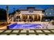 Beautiful pool at night, surrounded by lush landscaping and outdoor seating at 1537 Tomato Farm Cir, Mount Pleasant, SC 29464