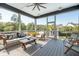 Inviting screened-in porch with stylish furniture, ceiling fan, and picturesque outdoor views at 1537 Tomato Farm Cir, Mount Pleasant, SC 29464