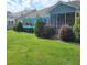 Inviting backyard with a hot tub, lush greenery, and a screened-in porch at 169 Woodbrook Way, Moncks Corner, SC 29461