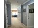 Hallway features a carpeted floor and neutral paint, leading into the living room at 169 Woodbrook Way, Moncks Corner, SC 29461