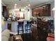 Open kitchen with dark wood cabinets, stainless steel appliances, and a breakfast bar at 169 Woodbrook Way, Moncks Corner, SC 29461