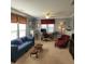 Carpeted living room featuring a computer desk, sofa, and abundant natural light at 169 Woodbrook Way, Moncks Corner, SC 29461