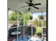 Cozy screened porch with seating, potted plants and a ceiling fan offers a relaxing outdoor space at 169 Woodbrook Way, Moncks Corner, SC 29461
