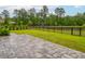 Beautiful backyard with paver patio, black iron fence, pond view, and partial basketball court at 1740 Agate Bay Dr, Mount Pleasant, SC 29466
