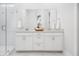 Elegant bathroom featuring double sinks, white cabinetry, quartz counters, and a glass-enclosed shower at 1740 Agate Bay Dr, Mount Pleasant, SC 29466