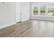 Bright bedroom with wood-look floors, large windows with views, and ample natural light at 1740 Agate Bay Dr, Mount Pleasant, SC 29466