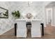 Dining room with black table, white-covered chairs, unique wallpaper, and elegant decor at 1740 Agate Bay Dr, Mount Pleasant, SC 29466