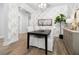 Dining room showcasing a black table, white chairs, wood floors, designer wallpaper, and decor at 1740 Agate Bay Dr, Mount Pleasant, SC 29466