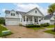 Light blue house featuring a white garage, front porch with white railings, and well-maintained landscaping at 1740 Agate Bay Dr, Mount Pleasant, SC 29466