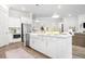 A bright kitchen showcases white cabinets, stainless steel appliances, and a spacious island with a sink at 1740 Agate Bay Dr, Mount Pleasant, SC 29466