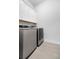 Convenient laundry room equipped with modern washer and dryer units and white cabinetry at 1740 Agate Bay Dr, Mount Pleasant, SC 29466