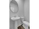 Half bathroom with a round mirror above the sink at 199 Belfort Pl, Summerville, SC 29486