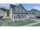 Inviting two-story home with a covered front porch and attached garage in a friendly neighborhood at 199 Belfort Pl, Summerville, SC 29486