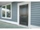 Close-up of the dark wood front door framed by white trim and sidelight windows at 199 Belfort Pl, Summerville, SC 29486