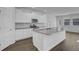 Kitchen features an island, stainless appliances, white cabinetry, and wood flooring at 199 Belfort Pl, Summerville, SC 29486