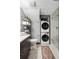 Well-lit bathroom with a stackable washer/dryer and tiled shower with glass doors at 2 Francis St # H, Charleston, SC 29403