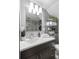Modern bathroom featuring a vessel sink, updated lighting, and a shelving unit for storage at 2 Francis St # H, Charleston, SC 29403