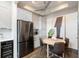 Eat-in kitchen with stainless steel appliances, modern cabinets, and a round wooden table at 2 Francis St # H, Charleston, SC 29403