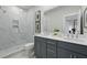 Modern bathroom featuring a double vanity, a large mirror, and a glass-enclosed shower with marble-like tile at 207 Somerset Acres Dr, Summerville, SC 29486