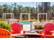 Community pool and seating area with lounge chairs and umbrellas for residents at 207 Somerset Acres Dr, Summerville, SC 29486