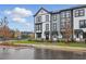 Modern townhomes featuring gray and white siding, nicely landscaped lawns, and updated architecture at 207 Somerset Acres Dr, Summerville, SC 29486