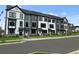 Beautiful townhomes featuring black and white exteriors, complemented by well-maintained landscaping at 207 Somerset Acres Dr, Summerville, SC 29486