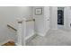 Upstairs hallway featuring neutral carpet, white doors and trim, and a view of the staircase at 207 Somerset Acres Dr, Summerville, SC 29486