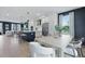 A modern kitchen and dining area with stainless steel appliances and a dark accent wall at 207 Somerset Acres Dr, Summerville, SC 29486