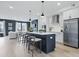 Open-concept kitchen with stainless steel appliances, white cabinets, and an island with barstool seating at 207 Somerset Acres Dr, Summerville, SC 29486